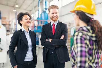 Quality control inspectors at the factory talking with workers