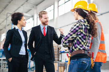 Quality inspectors talking to workers