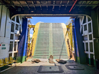 Inside the ferry as the gate opens, marking the end of the journey and arrival at port.