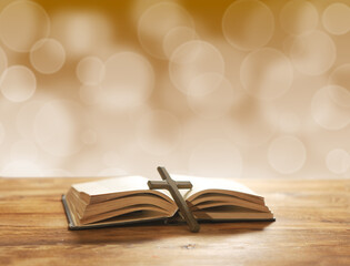 Holy Bible and Christian cross on a wooden table. Blessing and prayer