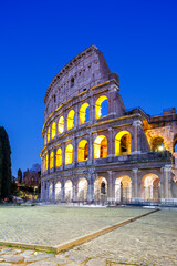 Naklejka premium Colosseum ancient amphitheater at night portrait format in Rome, Italy
