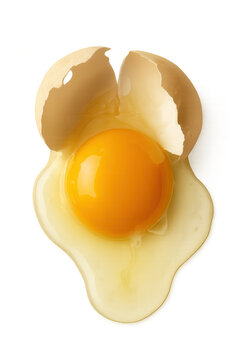 Fresh eggshell cracked open revealing a bright yellow yolk and clear egg white in a clean kitchen setting