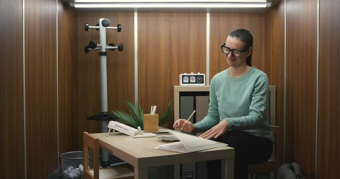 Businesswoman working in a tiny office