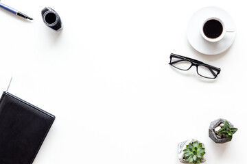 Writer or blogger workspace with notepad and ink, top view