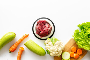 Natural pet food and ingredients - meat and vegetables zucchini, carrots and greens, cauliflower