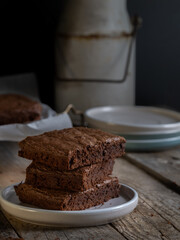 stack of chocolate brownies on a rustic table