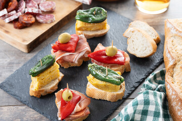 Traditional Spanish pintxos on wooden table