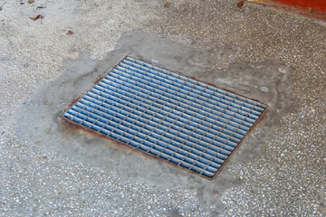 Metal Drainage Grate Embedded in Concrete Sidewalk Providing Urban Stormwater Management