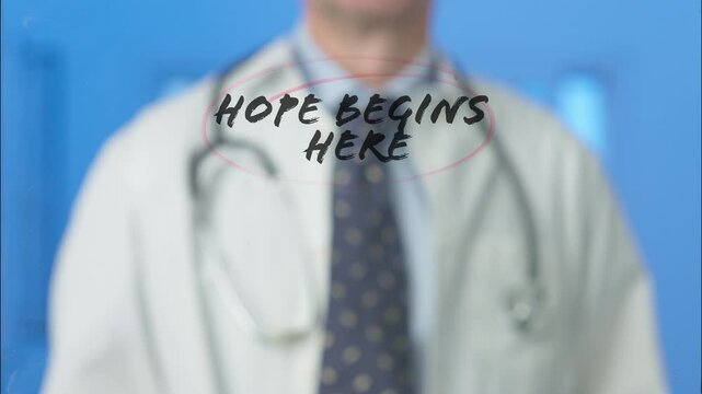 Medical professional writing motivational message hope begins here on transparent board with red marker, symbolizing healthcare optimism against blue background