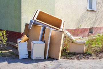 Household Appliances and Furniture Discarded Outside Residential Building Awaiting Proper Disposal...