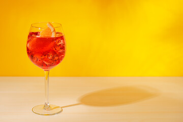 A cocktail arranged on a table against a light yellow background
