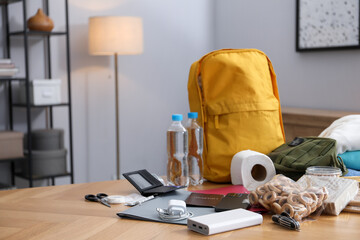 Survival kit. Different emergency supplies on wooden table indoors, space for text