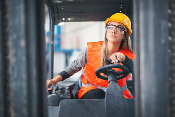 Female worker operating a forklift
