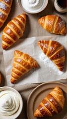 Golden Crescents: A Delicious Display of Buttery Croissants with Whipped Cream and Powdered Sugar, a Perfect Pastry Treat.