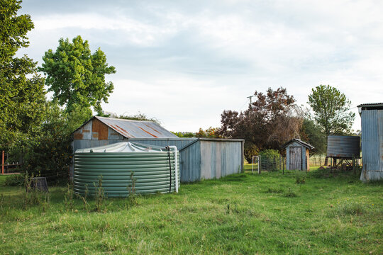 Rain water tank beside shed on rural farm property