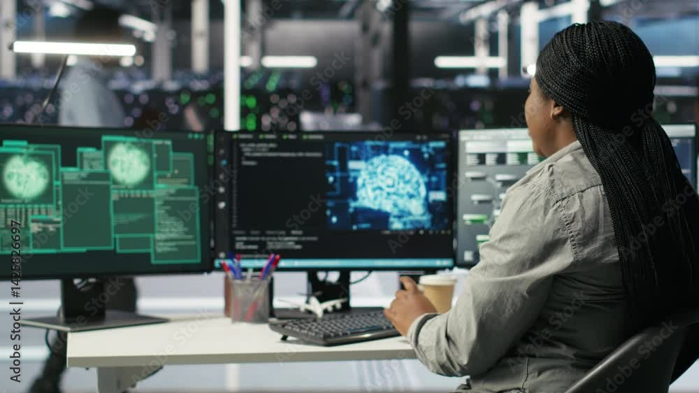 Poster server farm it expert responds to security breach alert displayed on computer monitor, working to se