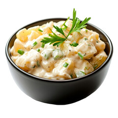 Potato salad with mayonnaise dressing chives and parsley garnish in a black bowl isolated on white background classic German cuisine healthy meal side dish appetizer cooked potato food photography