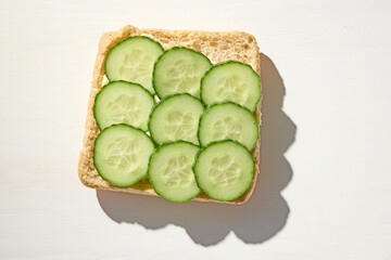bread slice with whipped butter smear and cucumber