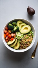 Vibrant and Nutritious Bowl: A Delicious Combination of Fresh Avocado, Broccoli, Quinoa, and Cherry Tomatoes for a Healthy Meal