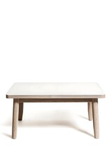 Fototapeta premium Wooden table with a white top sits on a white background