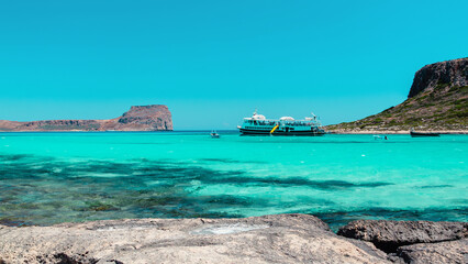 Fototapeta premium Serene coastal view with turquoise waters and distant rocky cliffs in Crete