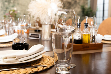 Elegant Restaurant Table Setting With Stacked Glasses Plate Napkin Woven Placemat