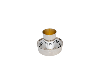 Elegant hammered silver goblet with gold-plated interior, placed on matching silver plate, isolated on white background for luxury and ceremonial use.