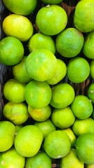 Fresh Green Limes in a Market Basket Display