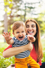 Portraits of happy family outdoors with their baby boy. Shallow DOF. Developed from RAW; retouched with special care and attention; Small amount of grain added for best final impression.