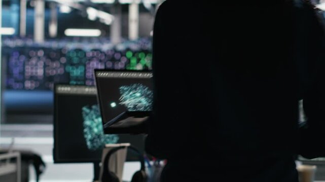 Server hub technician arriving in office, using AI visualization insights on PC to optimize system health. Data center IT specialist using computer node tree software to analyze gear issues, camera B