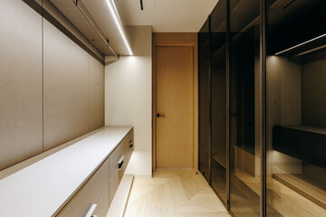 A spacious walkin closet that features numerous shelves, drawers, and a door