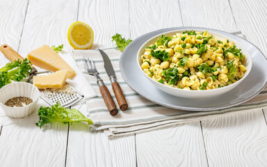 Pasta with green peas in a bowl, italian cuisine