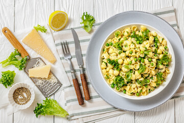 Pasta with green peas in a bowl, italian cuisine