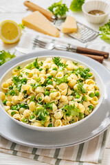 Pasta with green peas in a bowl, italian cuisine
