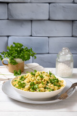 Pasta with green peas in a bowl, italian cuisine