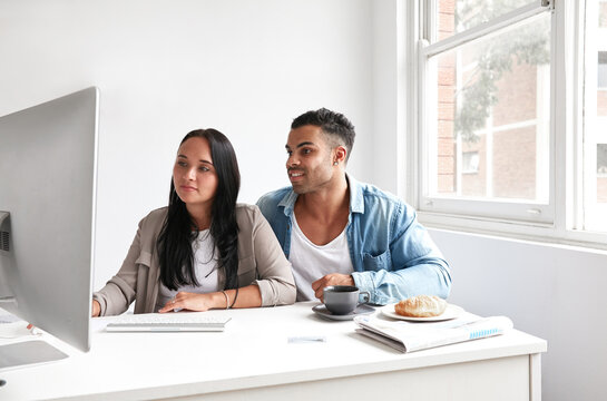 Couple paying bills online at home