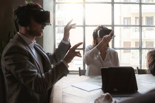 Business team testing virtual reality devices during a creative office meeting