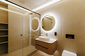 A welldesigned bathroom that includes a sink, toilet, shower, and a mirror