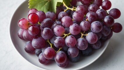 Fototapeta premium Red grape on a white plate with a clean white background