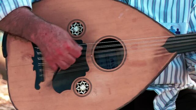 Outdoor oud playing. Traditional Middle Eastern musical instrument Ud
