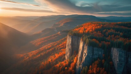 Naklejka premium Epic aerial view of autumn fall foliage in mountain landscape at sunset with green and yellow trees