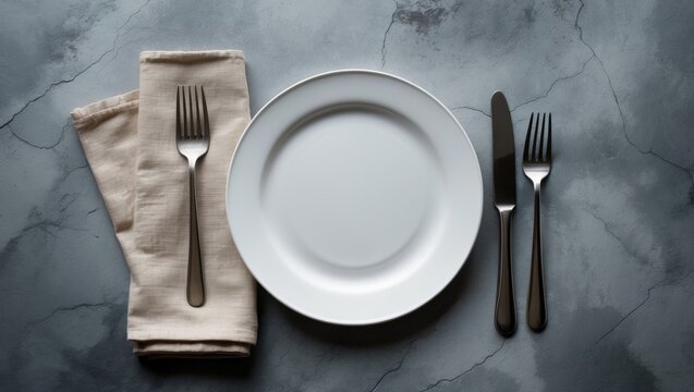 Stone table setting with white craft plate, cutlery, and napkin, featuring knife and fork on napkin from a top view with space for menu or recipes - Powered by Adobe