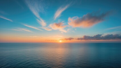 Naklejka premium Vibrant sunset over the ocean with blue sky and clouds