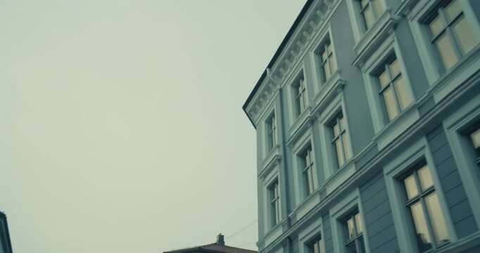 Discover the intricate architectural details of urban buildings under a moody sky, perfect for capturing atmospheric visuals and evocative cityscapes