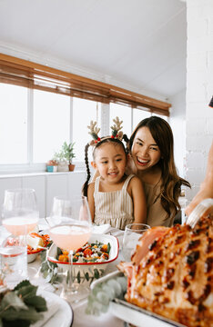 Mother and daughter giggling looking at the ham