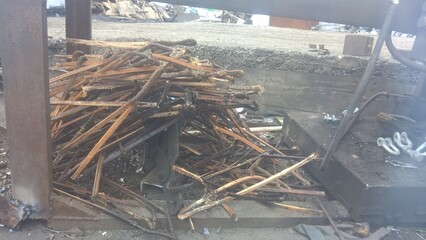 Pile of scrap metal and wood debris at a construction site during the afternoon