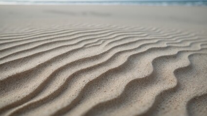 Close-up of beach sand texture featuring abstract, wavy patterns formed by ocean and wind