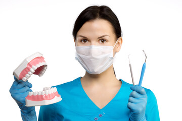 Dentist with tools. The concept of dentistry, whitening, oral hygiene, teeth cleaning with toothbrush and floss. Dentistry, taking care of a beautiful and healthy smile. . Stomatology