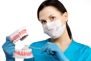 Dentist with tools. The concept of dentistry, whitening, oral hygiene, teeth cleaning with toothbrush and floss. Dentistry, taking care of a beautiful and healthy smile. . Stomatology