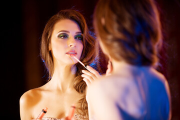 Young beautiful girl in the mirror in a nightclub. Beauty woman. Fashionable stylish model. Luxury Lady.